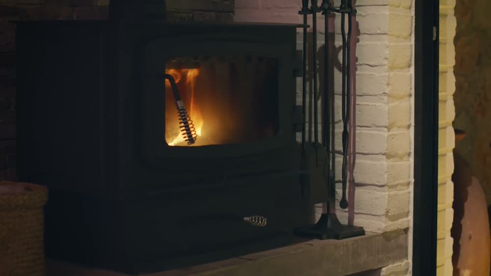 A hand warming in front of a glowing heater